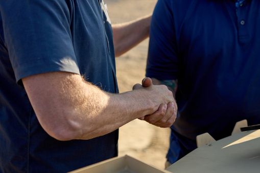 Two men shaking hands — Applied CAx Siemens defense software