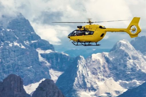 Helicopter flying over snowy mountains — Applied CAx Siemens aerospace software